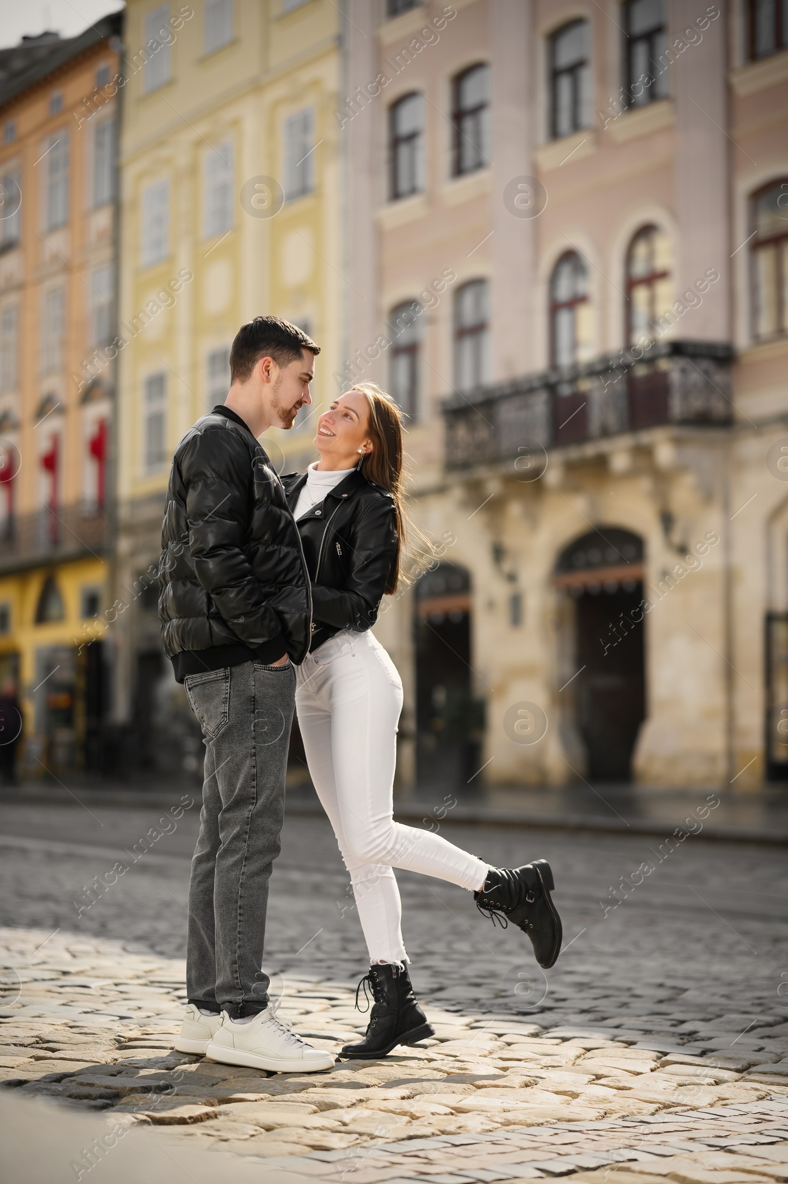 Photo of Lovely young couple together on city street. Romantic date