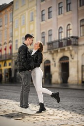 Photo of Lovely young couple together on city street. Romantic date