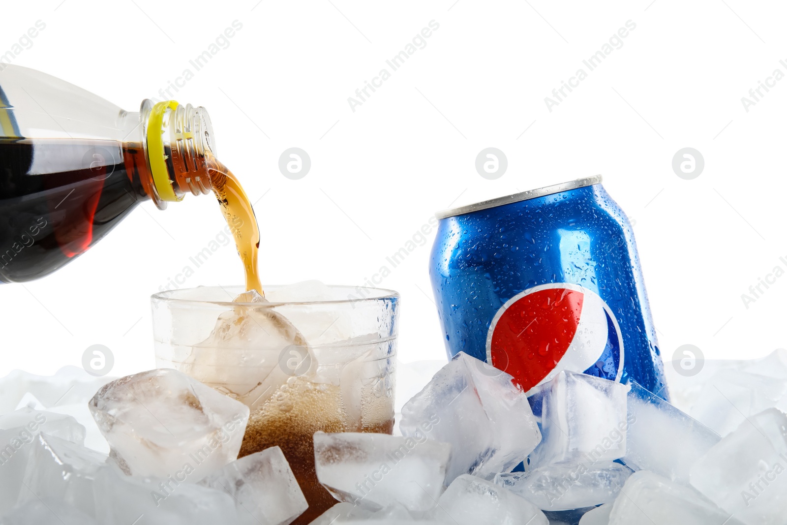 Photo of MYKOLAIV, UKRAINE - FEBRUARY 11, 2021: Pouring Pepsi from plastic bottle into glass on ice cubes against white background, closeup