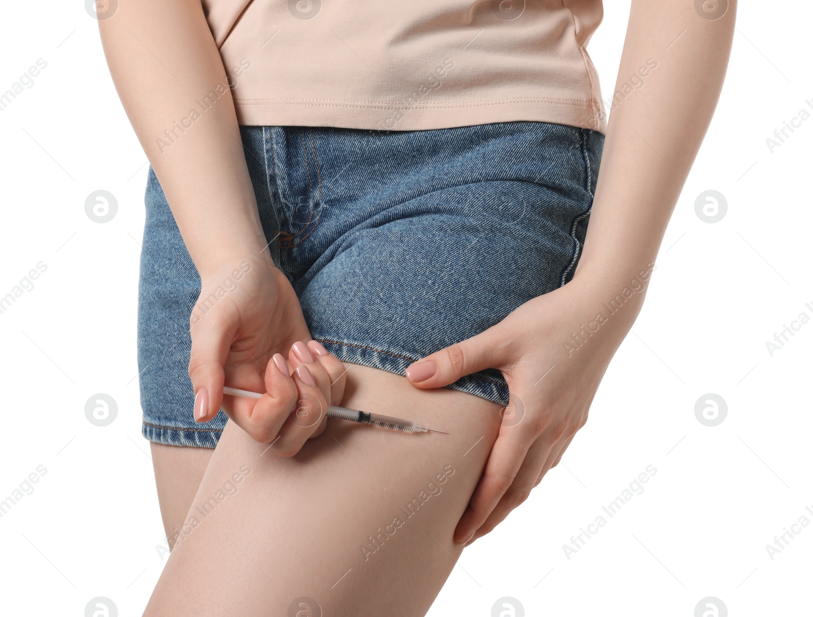 Photo of Diabetes. Woman making insulin injection into her leg on white background, closeup