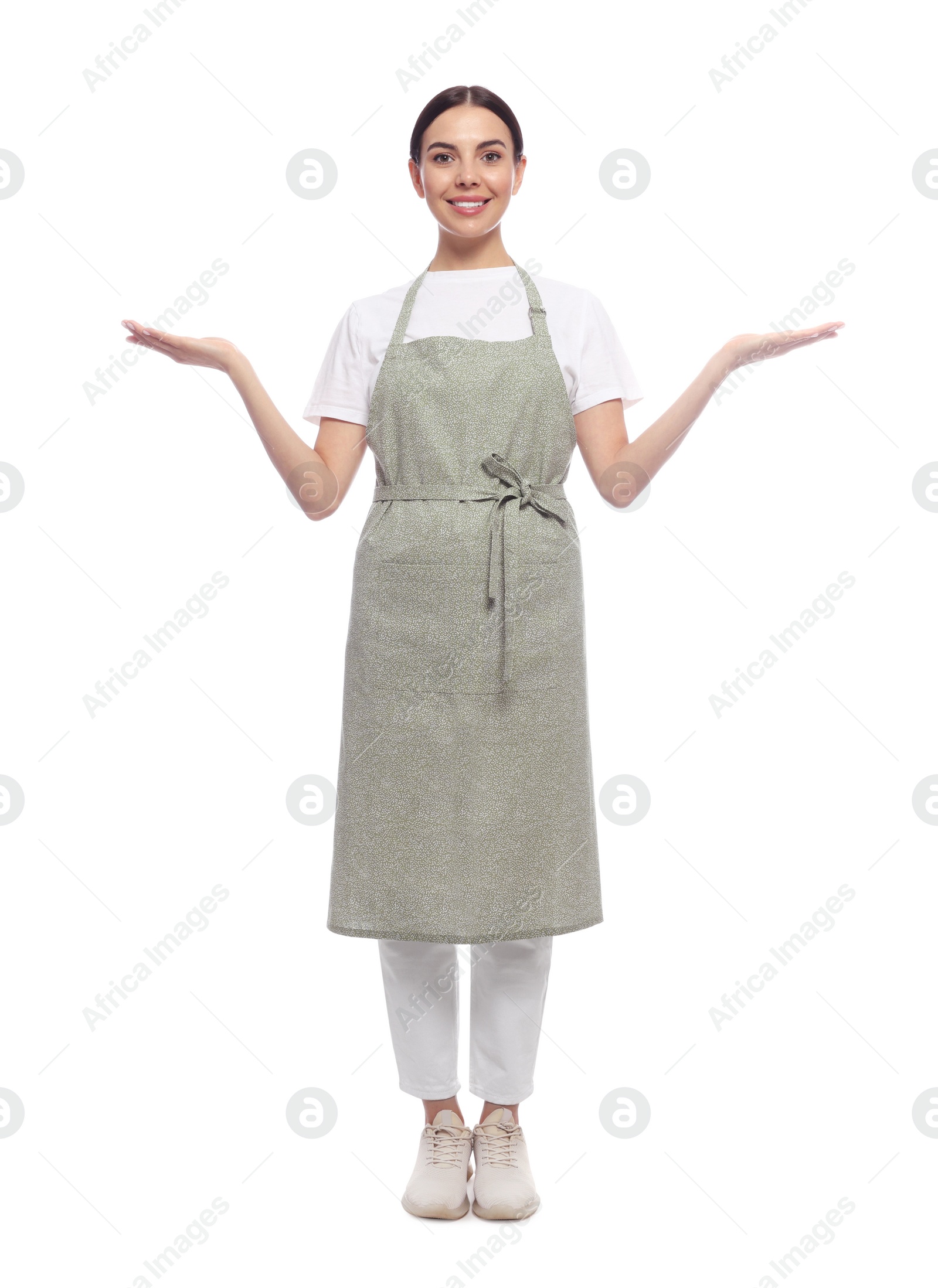 Photo of Young woman in light green apron on white background