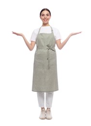 Photo of Young woman in light green apron on white background
