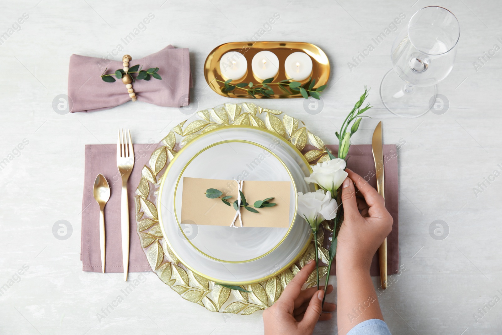 Photo of Woman setting table for festive dinner, top view