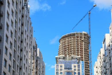 Photo of Unfinished building against blue sky. Construction safety rules