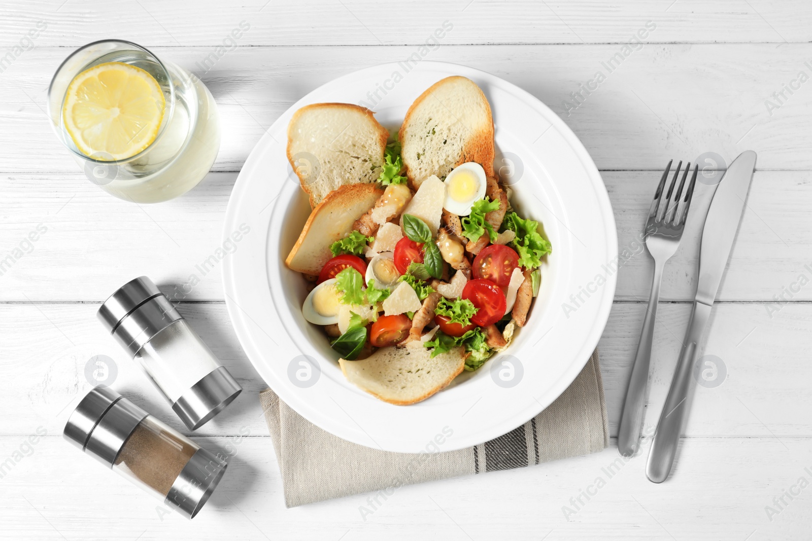 Photo of Plate with delicious fresh salad on table, top view