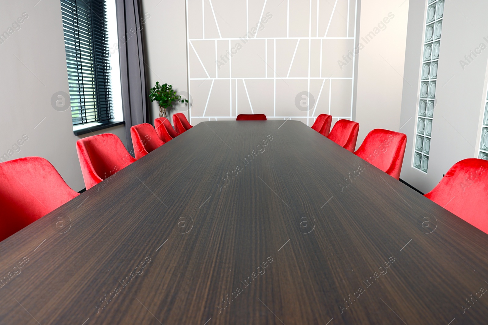 Photo of Empty conference room with stylish red office chairs and large wooden table