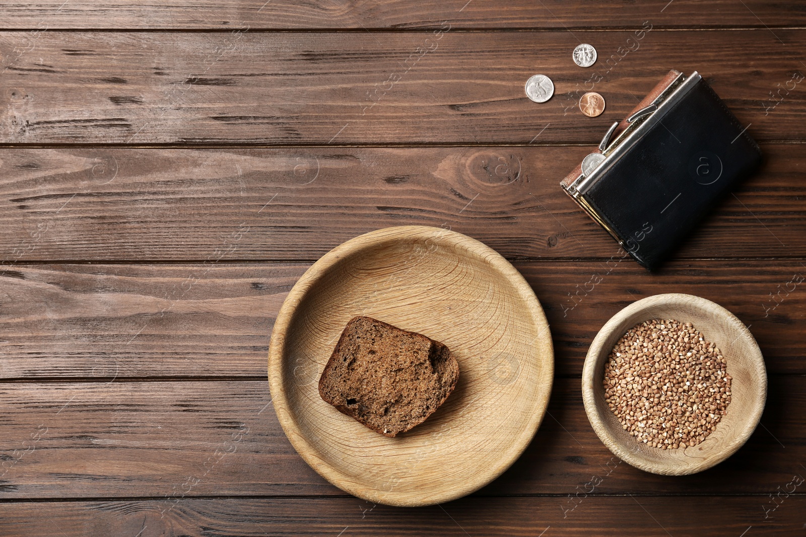 Photo of Flat lay composition with food, coins and space for text on wooden background. Poverty concept