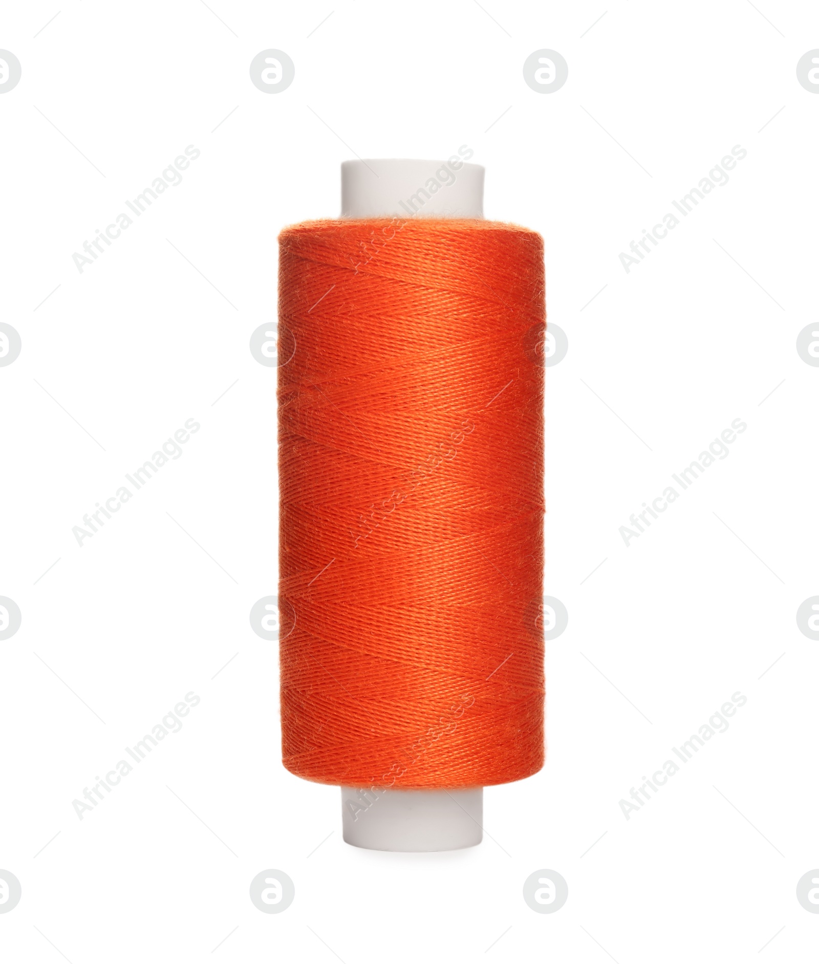 Photo of Spool of orange sewing thread isolated on white