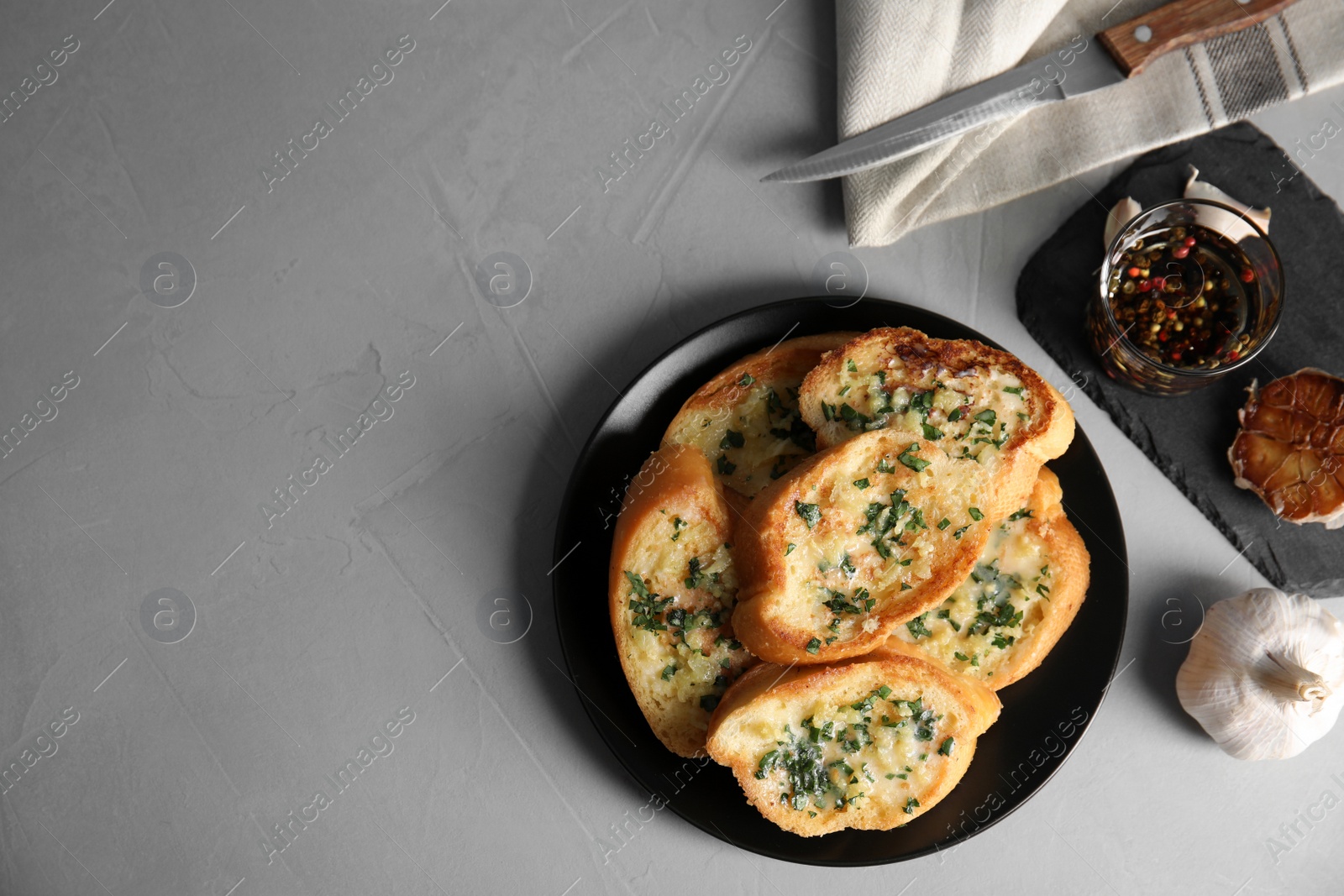 Photo of Flat lay composition with tasty garlic bread and space for text on table