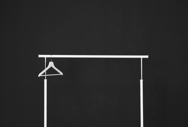 Wardrobe rack with hanger against dark background