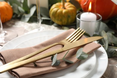 Photo of Beautiful autumn table setting. Plates, cutlery and decor, closeup