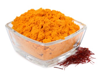 Photo of Bowl with saffron powder and dried flower stigmas on white background