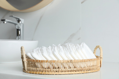 Photo of Basket with baby diapers on counter in bathroom