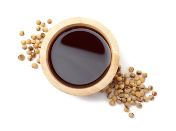 Tasty soy sauce in bowl and soybeans isolated on white, top view
