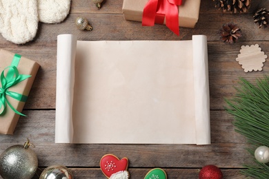 Flat lay composition with empty card and Christmas decorations on wooden table, space for text. Writing letter to Santa Claus