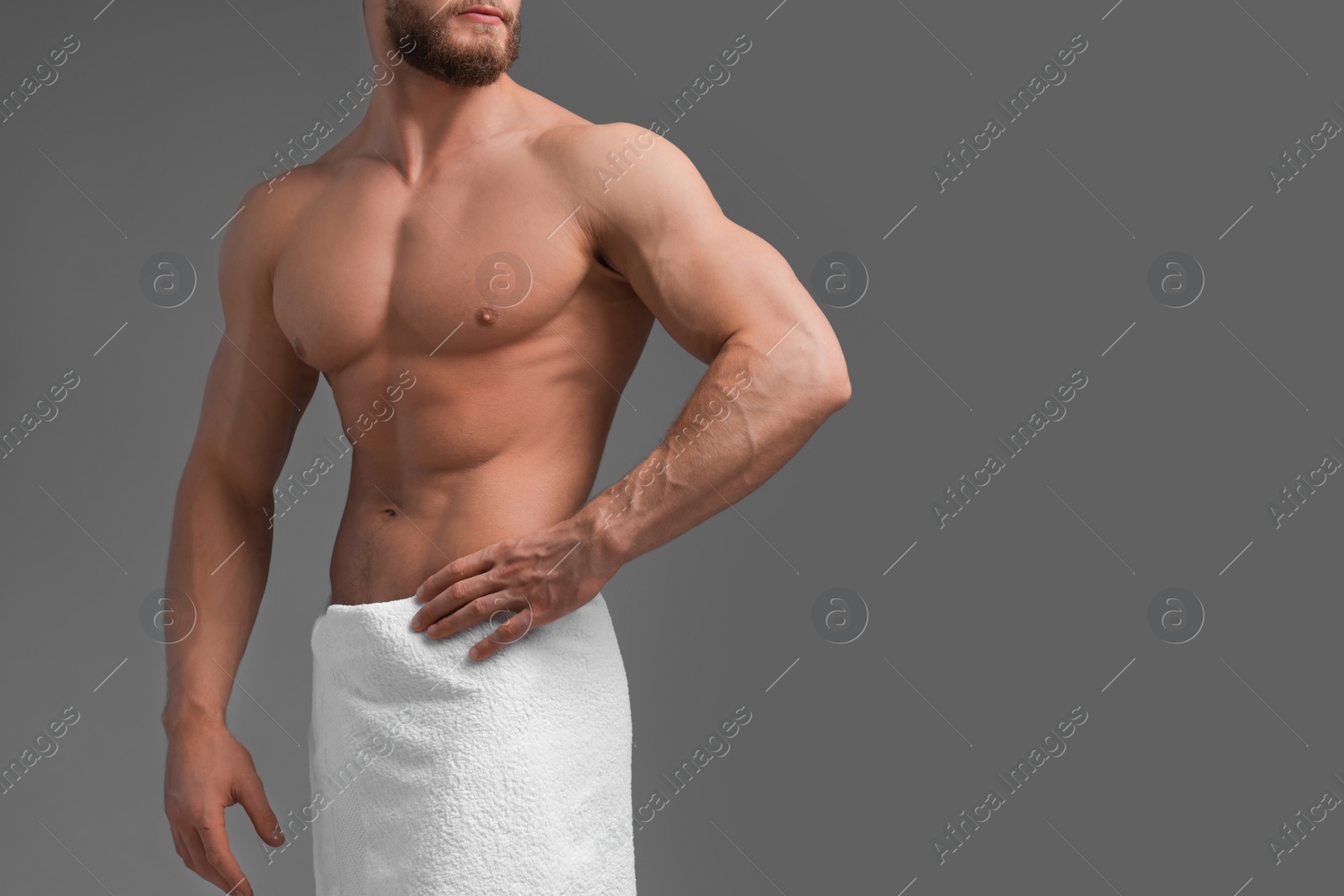 Photo of Muscular man on grey background, closeup and space for text. Sexy body