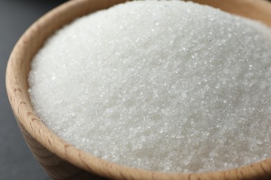 Granulated sugar in bowl on table, closeup