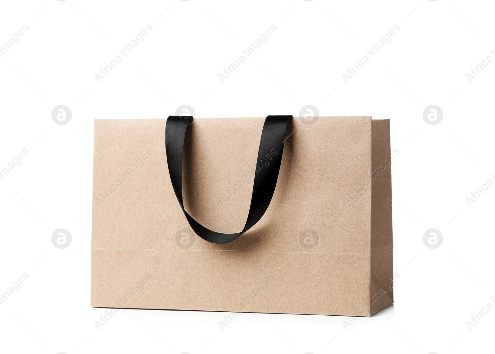 Photo of Paper shopping bag with ribbon handles on white background. Mockup for design