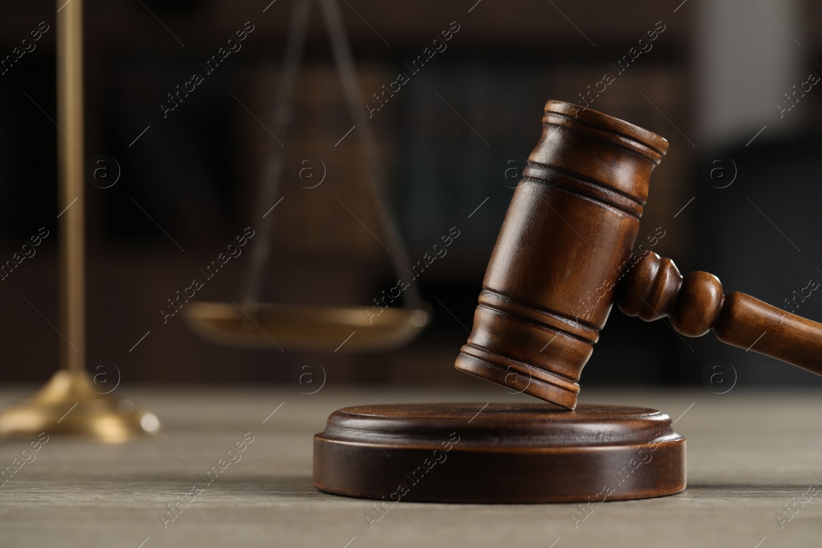Photo of Wooden gavel on table against dark background. Space for text