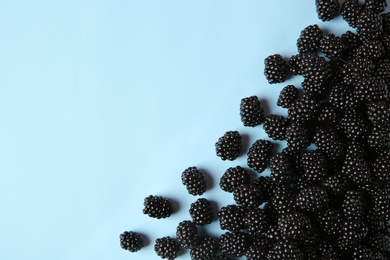 Photo of Flat lay composition with ripe blackberries on blue background. Space for text