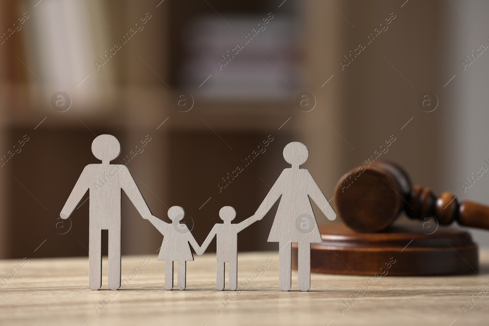 Photo of Family law. Figure of parents with children and gavel on wooden table, space for text