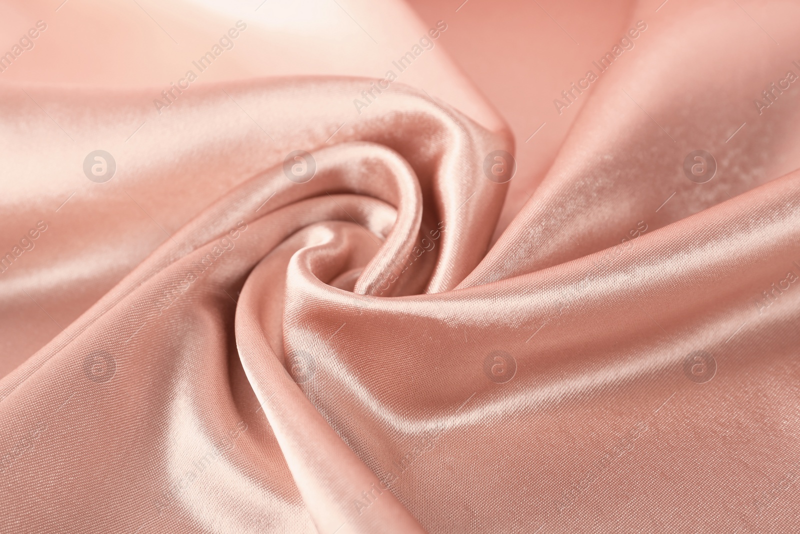 Photo of Texture of rose gold silk as background, closeup