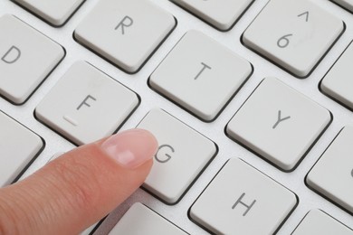 Photo of Woman pressing button on computer keyboard, closeup