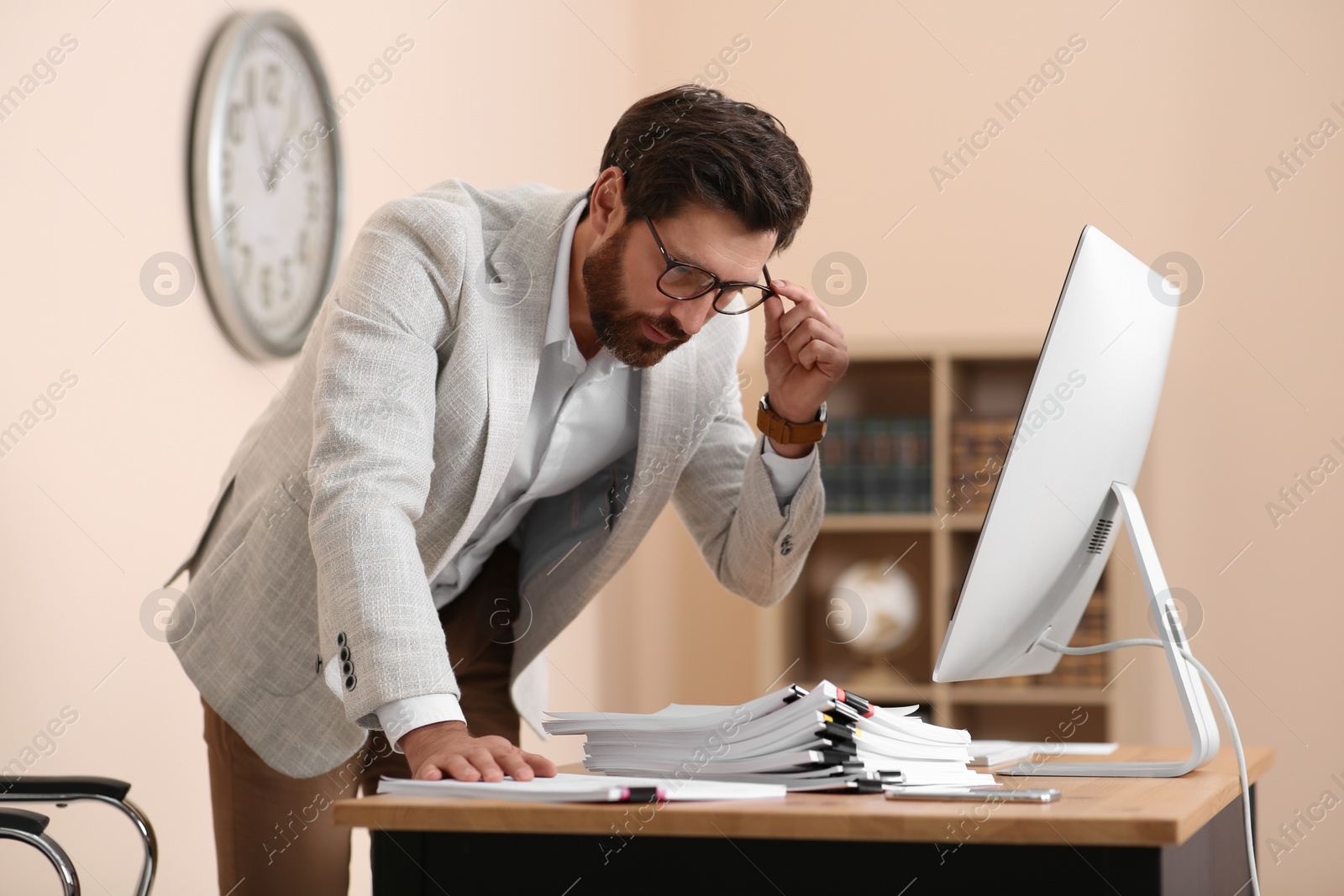 Photo of Businessman working with documents at wooden table in office