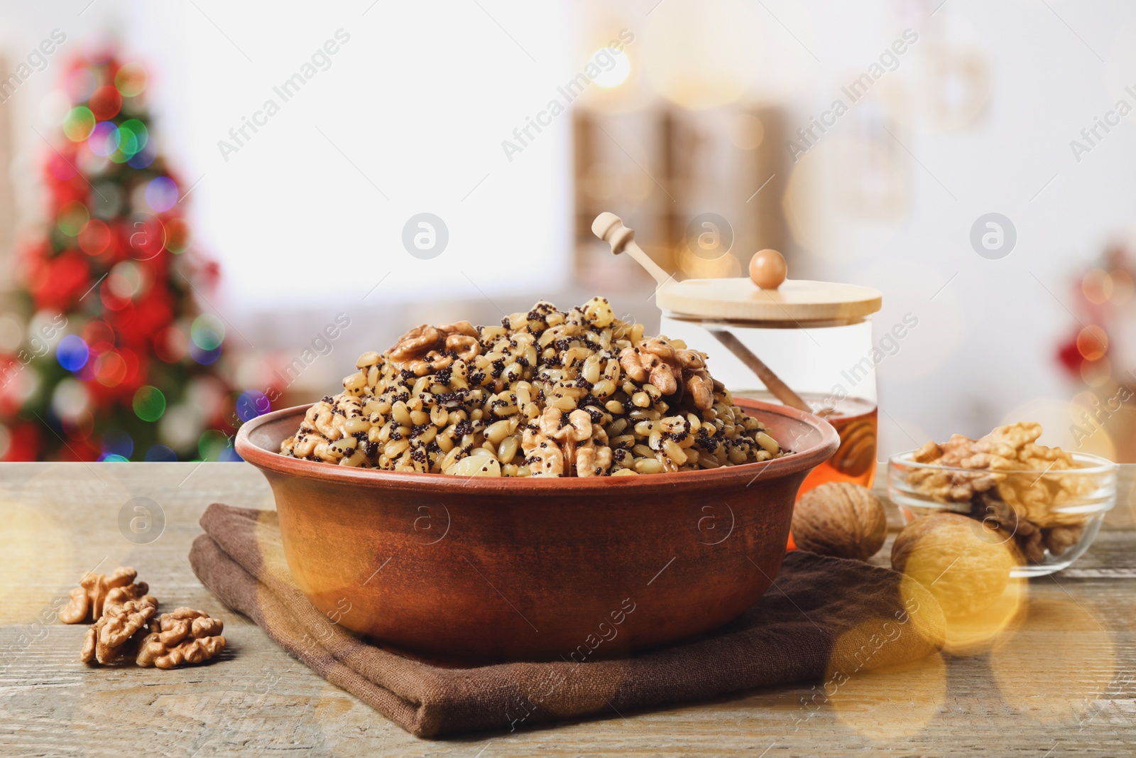 Image of Traditional Christmas slavic dish kutia on wooden table in decorated room