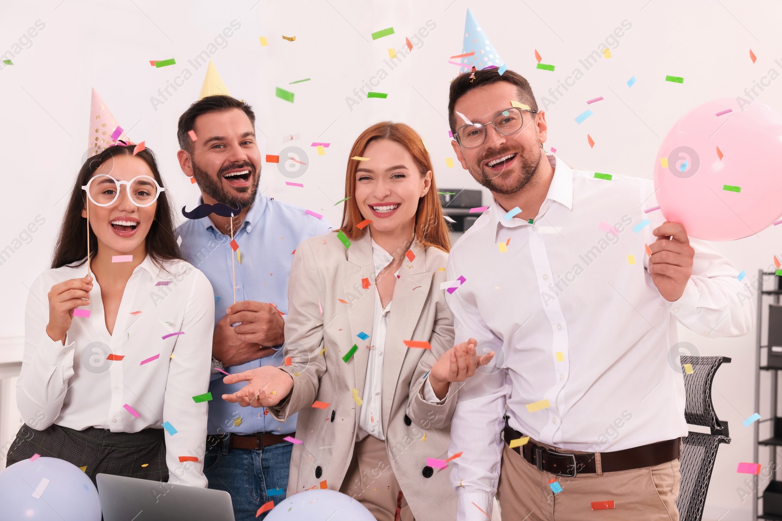 Photo of Coworkers having fun during office party indoors