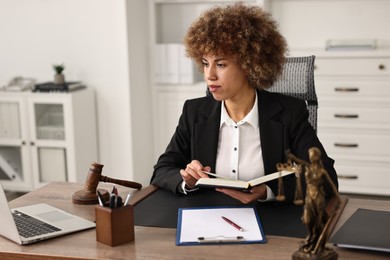 Notary with notebook at workplace in office