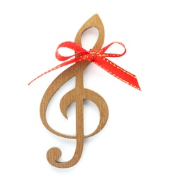 Wooden treble clef with red bow knot on white background. Christmas music concept