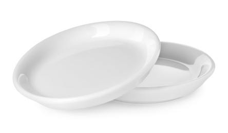 Photo of New ceramic plates on white background. Tableware