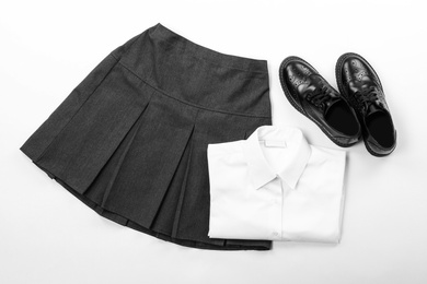 Photo of New stylish school uniform on white background, top view