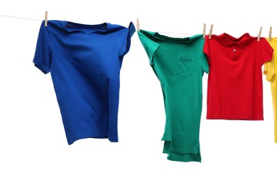 Colorful t-shirts drying on washing line isolated on white