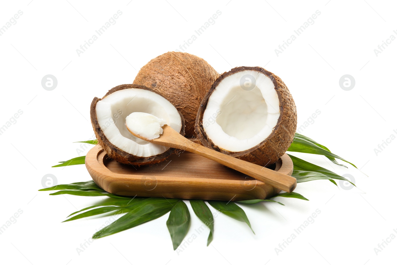 Photo of Spoon with coconut oil and nuts on white background