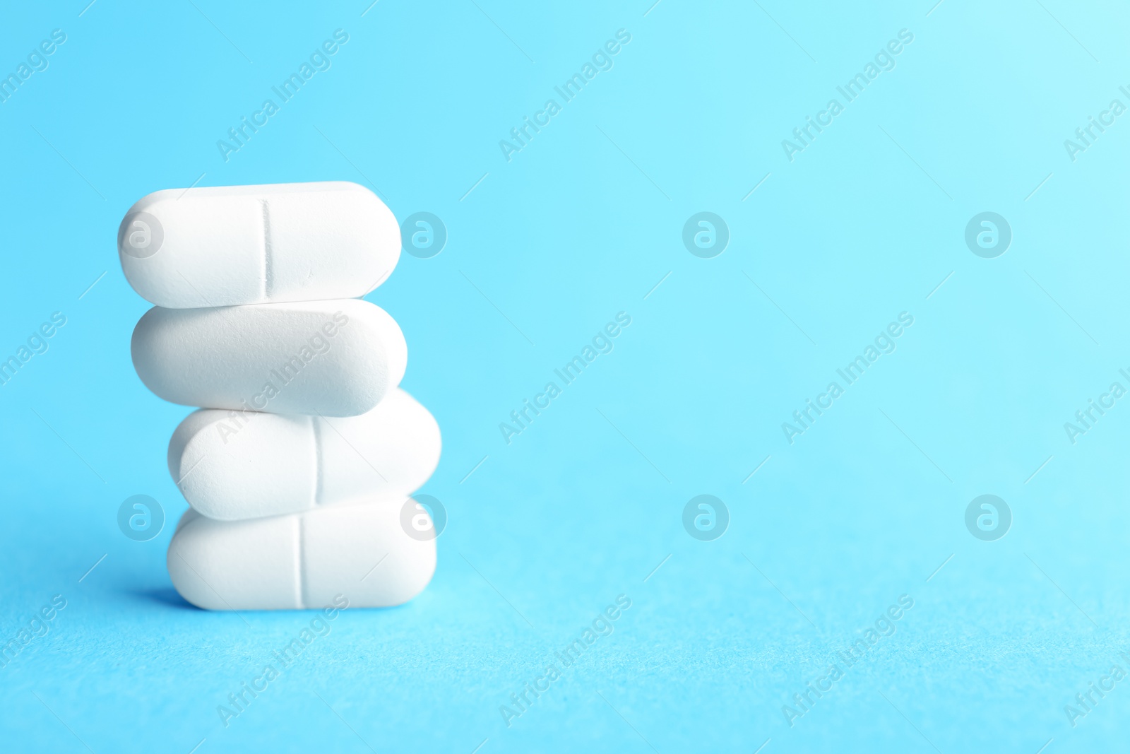 Photo of White pills on color background