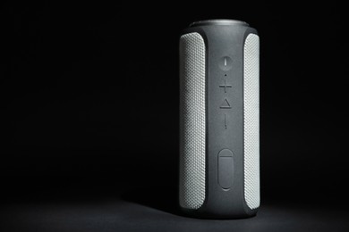 Photo of One portable bluetooth speaker on black background, space for text. Audio equipment