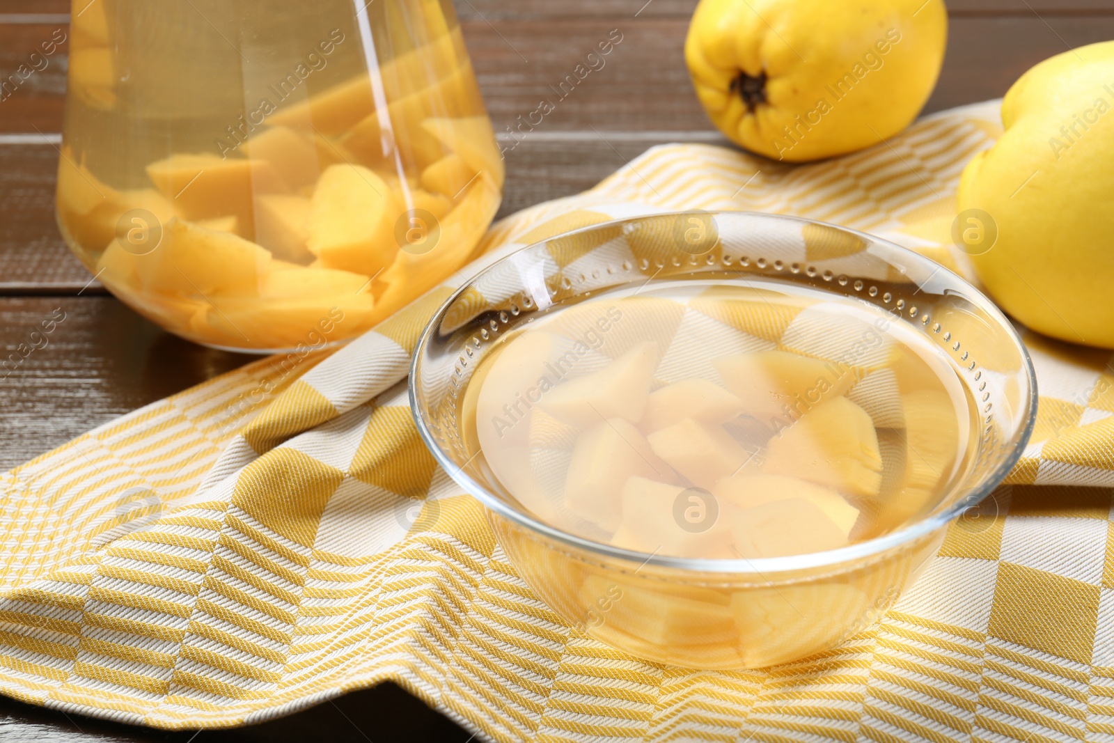 Photo of Delicious quince drink and fresh fruits on wooden table, closeup