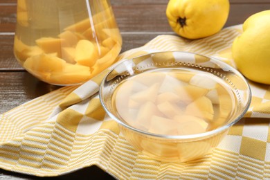 Delicious quince drink and fresh fruits on wooden table, closeup