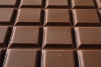 Photo of Delicious milk chocolate bar as background, closeup