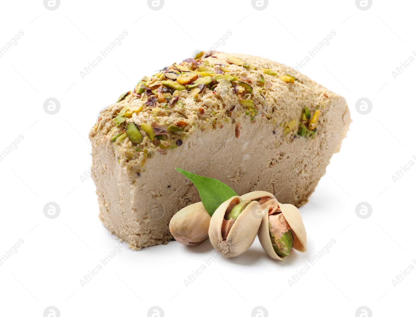 Image of Tasty halva, pistachio nuts and green leaf isolated on white