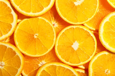 Slices of juicy orange as background, top view