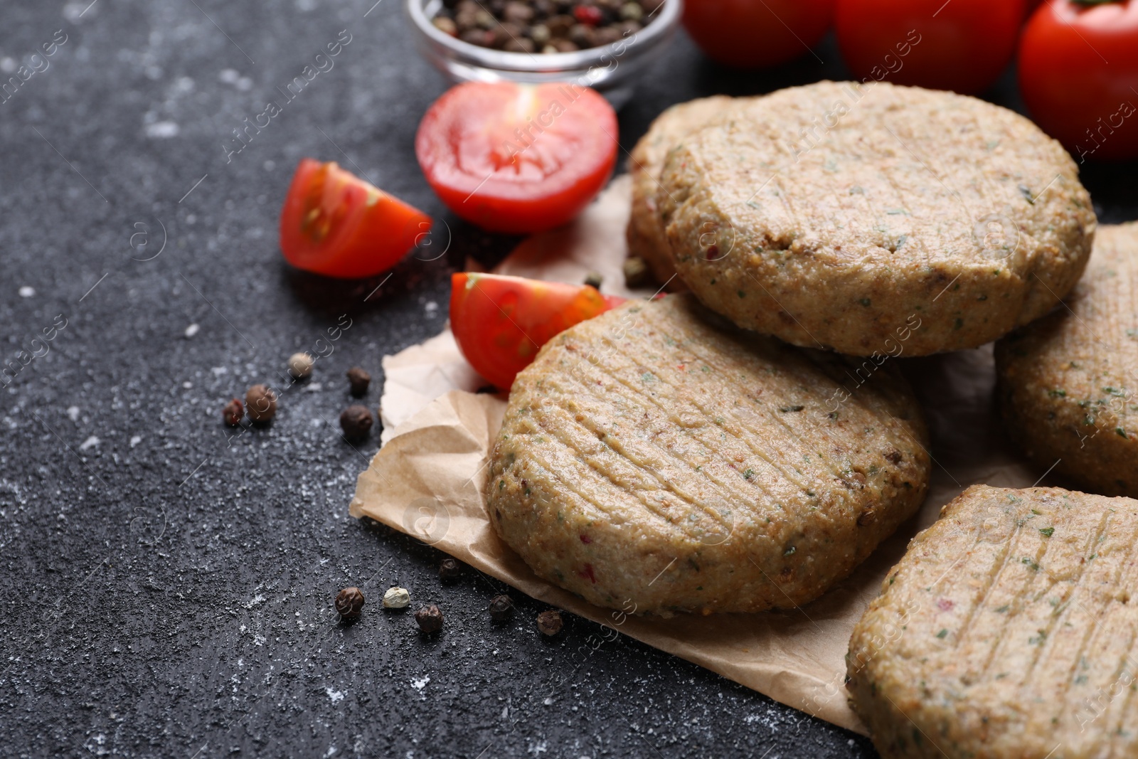 Photo of Tasty vegan cutlets and products on grey table, closeup. Space for text