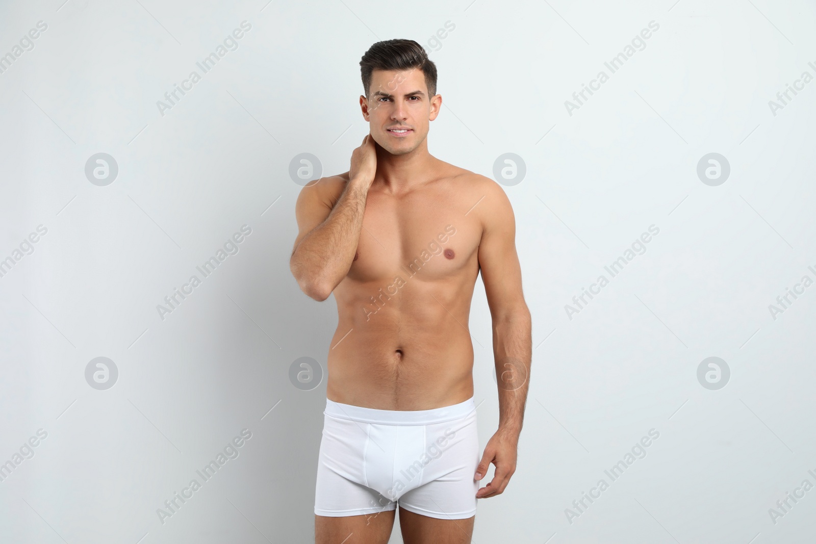 Photo of Handsome man in underwear on white background