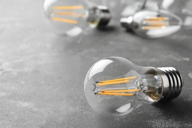 Photo of Vintage lamp bulb on grey background. Space for text