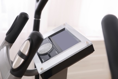 Photo of Control panel of modern elliptical machine cross trainer on blurred background, closeup