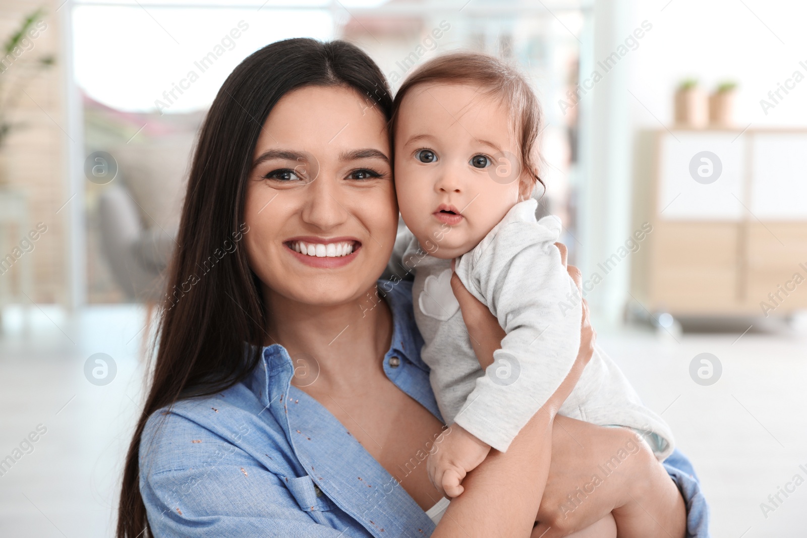 Photo of Portrait of young mother and her adorable baby at home