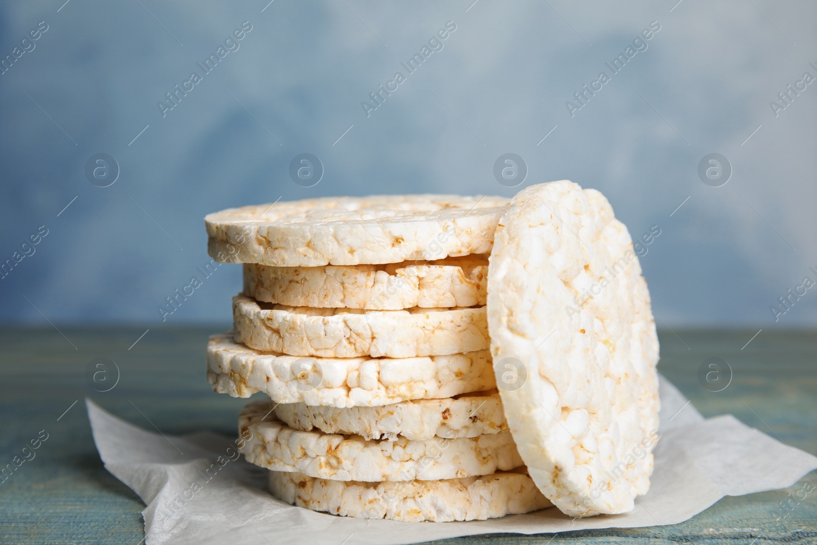 Photo of Stack of crunchy rice cakes on wooden table