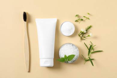 Flat lay composition with toothbrush, toothpaste and herbs on beige background